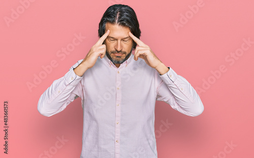 Middle age handsome man wearing business shirt with hand on head for pain in head because stress. suffering migraine.