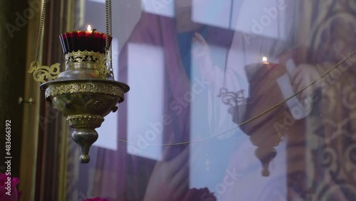 Close-up of a candle with an icon in a church