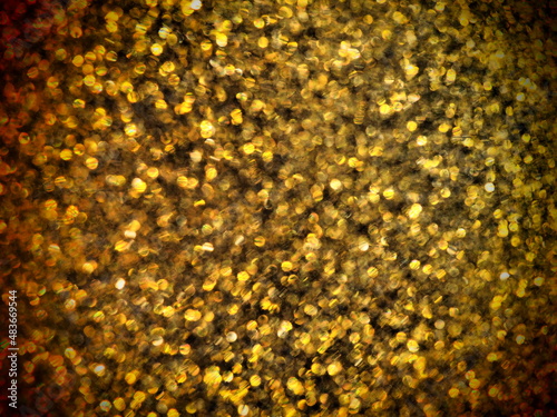 Bokeh light of gold glitters. Golden glitter texture background. Sparkling glitter wrapping paper with sequins and sparkles. Festive golden bokeh and glitter. Beautiful macro background photo