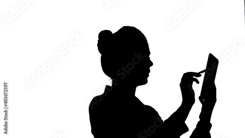 Silhouette of Businesswoman using tablet