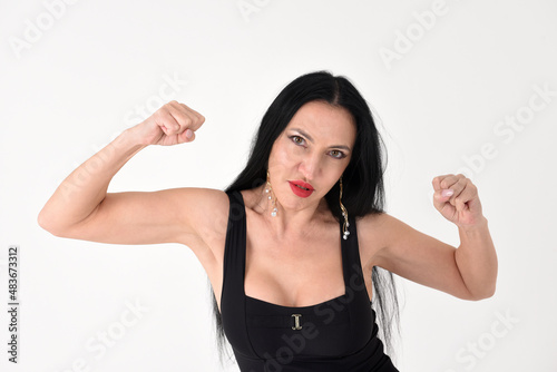Fotografie Portrait of a beautiful brunette woman in an explosive fighting pose ready to fi