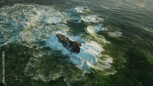 Foamy Sea Waves Crashing On The Rock At Oudekraal Beach In Cape Town, South Africa - aerial, slow motion photo