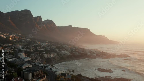 Misty Sky Over Coastal Suburbs At Camps Bay Beach With Twelve Apostles Mountain Range In Cape Town, South Africa. Aerial Wide