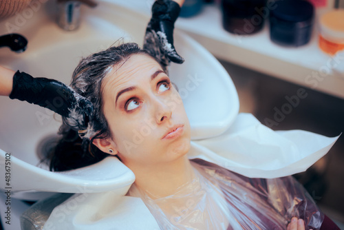 Worried Woman Having her Hair Washed by the Hairdresser  photo