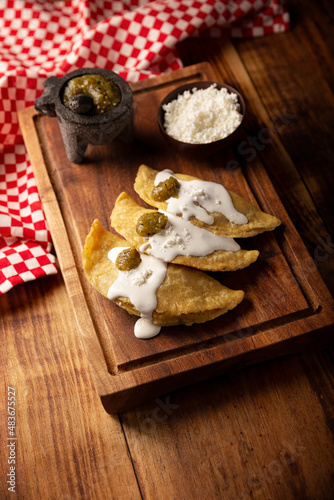 Quesadillas fritas. Traditional Mexican appetizer "garnacha"..Deep Fried handmade corn tortilla that can be filled with a wide variety of ingredients, cheese, pork rinds, meat, etc.
