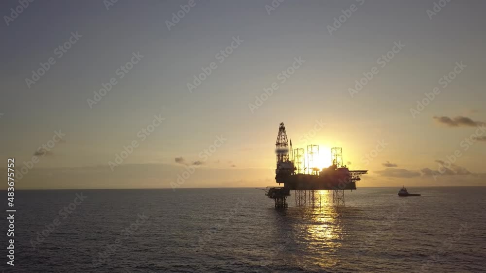 Aerial view from a drone of an offshore jack up rig at the offshore location during sunrise time Aerial view from a drone of an offshore jack up rig at the offshore location during sunrise time