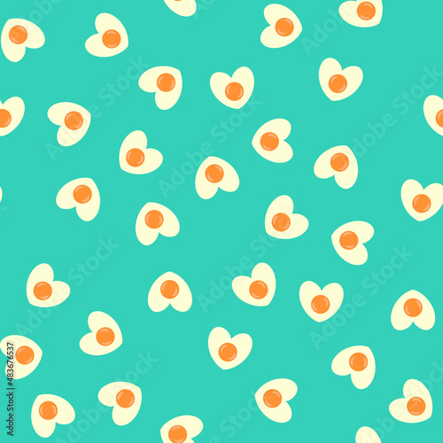 Seamless pattern with heart shaped egg. Abstract Valentine's Day pattern with fried eggs. Random, chaotic blue background with cute omelette.