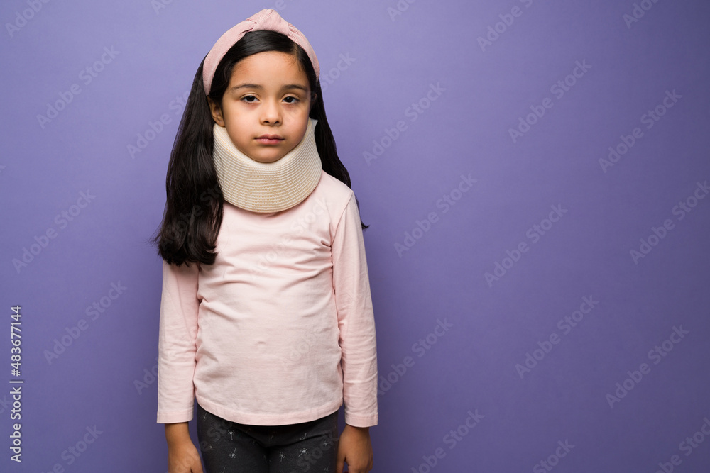 Studio shot of a kid with a cervical collar Studio shot of a kid with a cervical collar