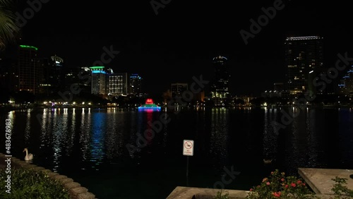 A landscape of Lake Eola surrounded by buildings and lights at night in Orlando, Florida shot in 4K photo