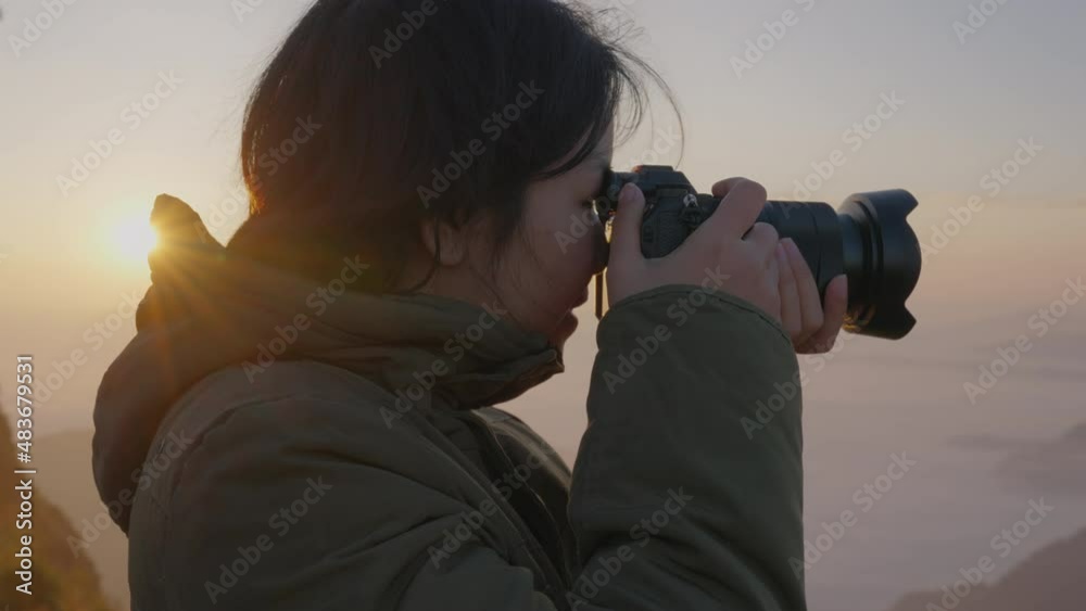 Adult asia mature people look at cliff hill view smile relax filming sun light shot cloud dusk dawn sky. Happy youth culture enjoy stand at top peak hike plain rural photo tour fresh fog mist scene.