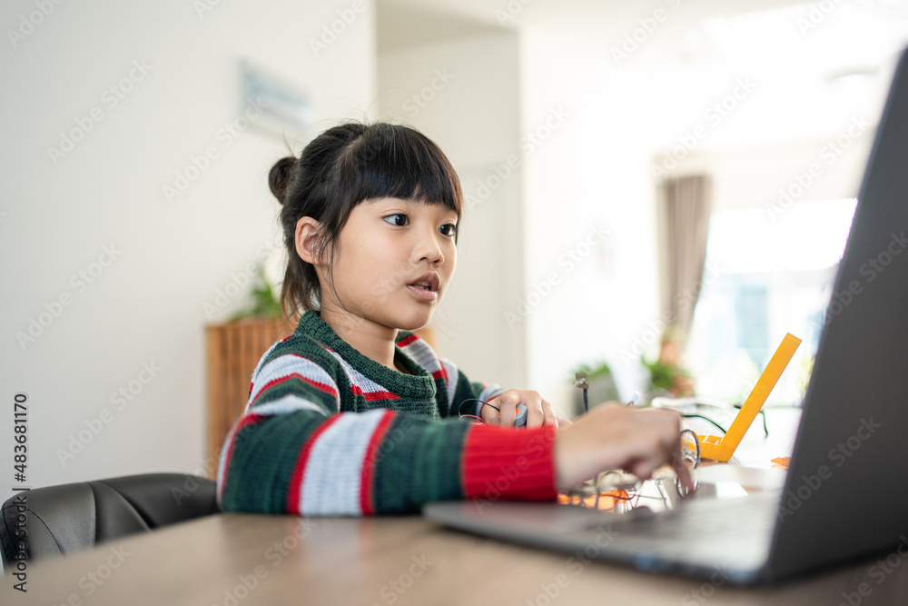 Asian girls enjoy learning online tutor training course at desk table enjoy making and fixing electrical robot car Asian girls enjoy learning online tutor training course at desk table enjoy making and fixing electrical robot car