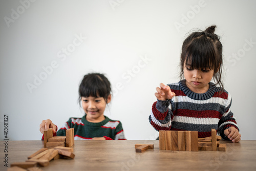 Child Girl Playing With Wooden Toy Blocks At Home