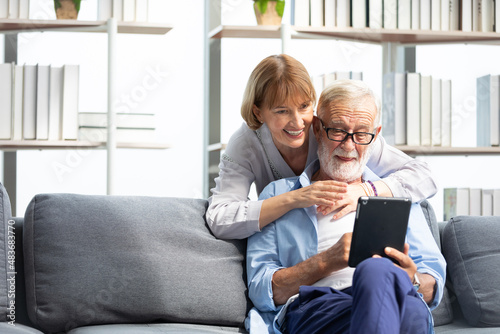 senior couple, elderly man and woman using tablet on sofa © offsuperphoto