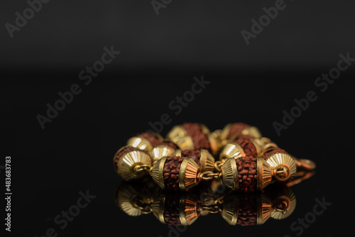 a string of gold chain link rudraksh prayer beads photo