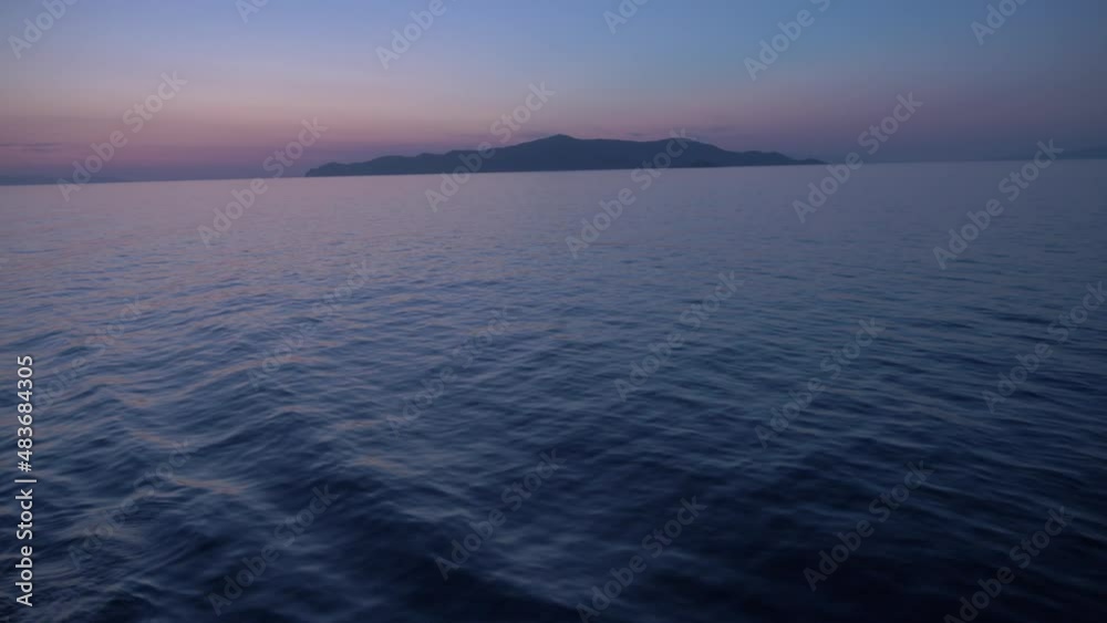 Ship leaving Piraeus port on a Beautiful sunset lights, the Ocean is quiet. Shot onboard a boat Ship leaving Piraeus port on a Beautiful sunset lights, the Ocean is quiet. Shot onboard a boat