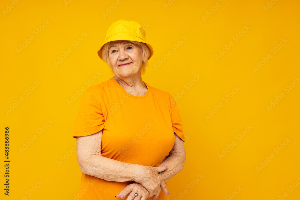 smiling elderly woman happy lifestyle in a yellow headdress close-up emotions