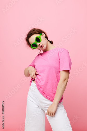 portrait of a young woman in a pink T-shirt green glasses Youth fashion Studio © Tatiana