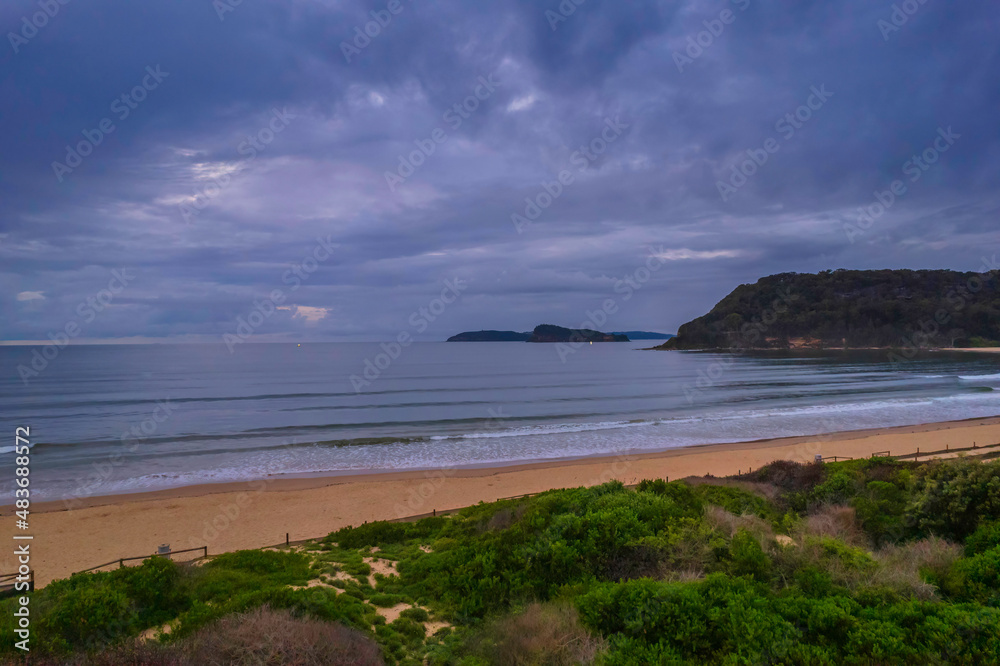 Aerial sunrise seascape with overcast sky and rain clouds