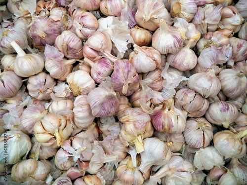a bunch of garlic on the counter in the store
