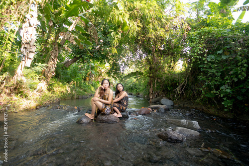Portrait of beautiful two young Asian girls in river