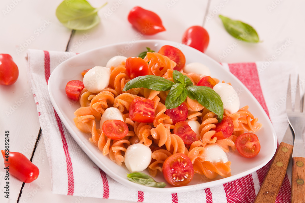 Fusilli pasta with cherry tomatoes and mozzarella cheese. Fusilli pasta with cherry tomatoes and mozzarella cheese.