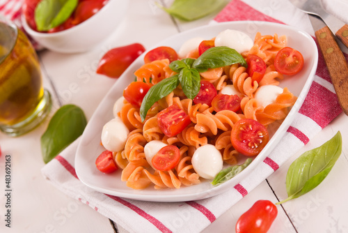 Fusilli pasta with cherry tomatoes and mozzarella cheese.