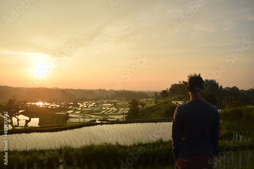 person in the rice terrace watching sunrise