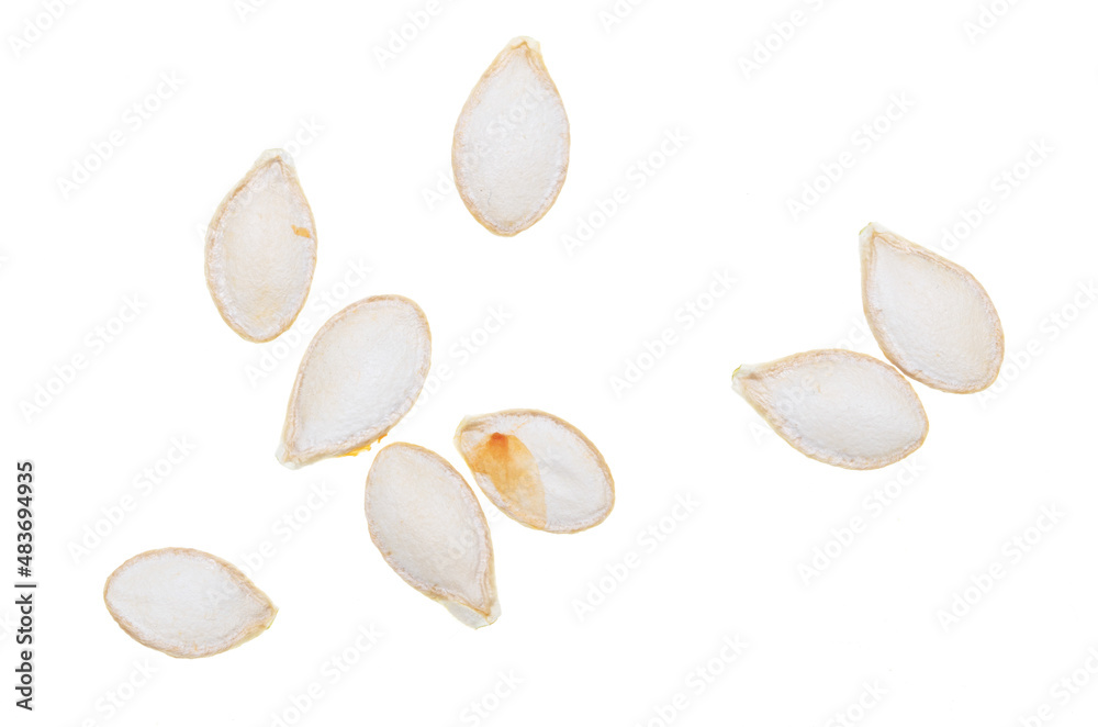 Close-up of pumpkin seeds on a white background. Macro