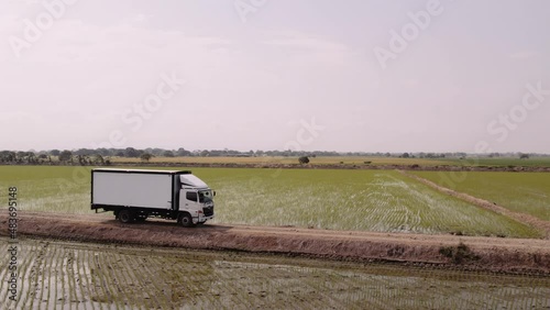 Drone shot of Hino truck cruising rice fields. photo