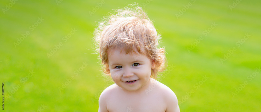 Banner with spring child face. Little baby in diaper playing in nature on the green grass. Baby and summer sunny weather. Blonde kid, laughing emotion, happy smiling face. Banner with spring child face. Little baby in diaper playing in nature on the green grass. Baby and summer sunny weather. Blonde kid, laughing emotion, happy smiling face.