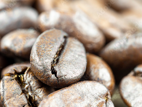 Fototapeta Naklejka Na Ścianę i Meble -  Abstract background of coffee beans.Coffee beans are Robusta. Robusta is praised for its high caffeine content, low sugar content and low acidity. Selective focus.