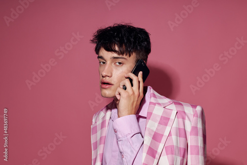 handsome guy with a phone in hand pink blazer fashion elegant style Lifestyle unaltered