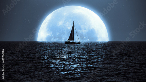 Full Moon and Millky way rising above ocean sea horizon with sailing boat silhouette.