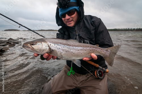 Happy angler with silver sea trout