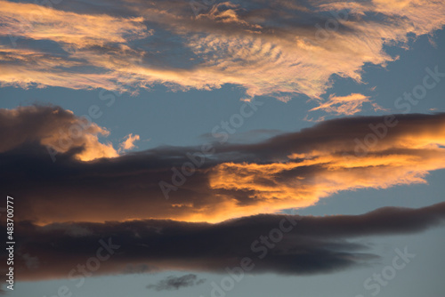 Colorful orange and blue dramatic sky with clouds for abstract background over Graz, Austria.