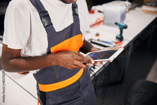 African factory worker using tablet