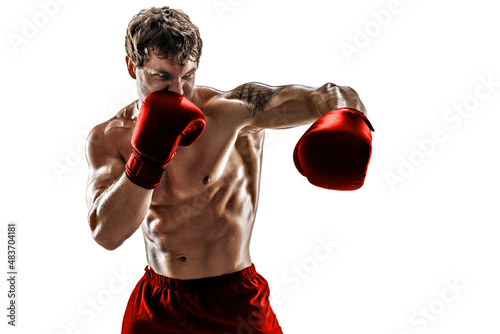 Portrait of muscular boxer who training and practicing left hook in red gloves on white background.