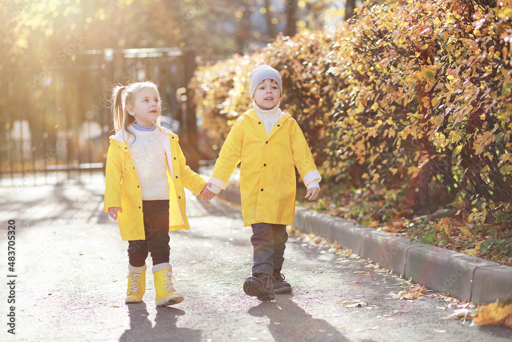 Children walk in the autumn park Children walk in the autumn park