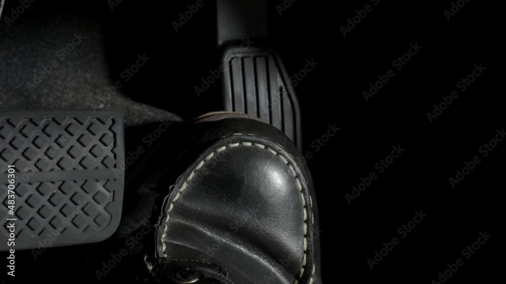 Accelerate and Brake. Foot pressing foot pedal of a car to drive ahead