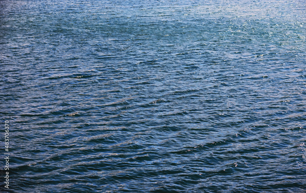 Water surface. The texture of the water. Waves on the lake in windy weather.