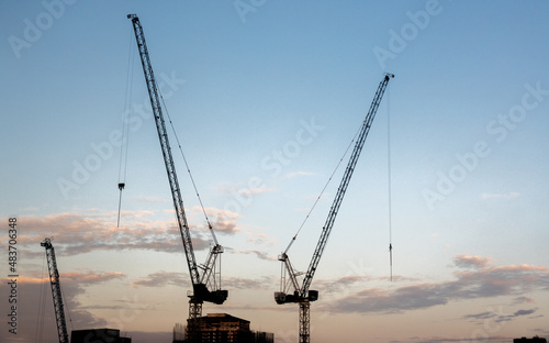 Tower cranes on a job site constructing a skyscraper