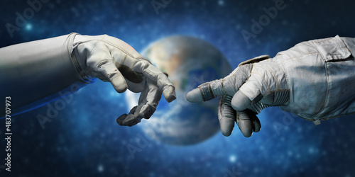 Astronaut hands and on outer space background. Elements of this image furnished by NASA. © Tryfonov