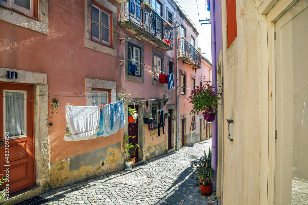 Fototapeta premium Alfama Lisboa district narrow street colored houses. Lisbon, Portugal