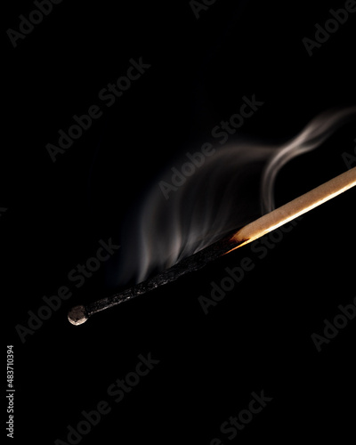 extinguished match isolated on a black background