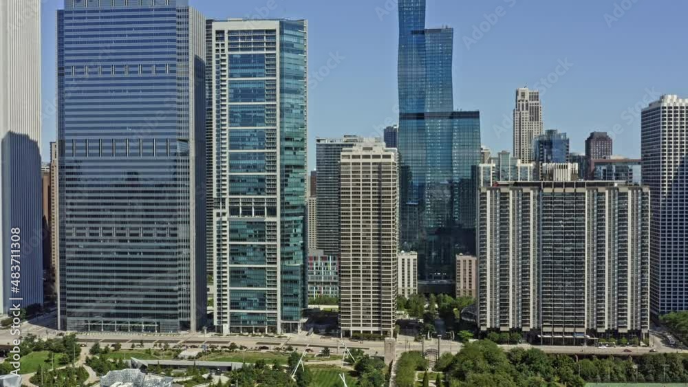 Chicago Illinois Aerial v61 establishing shot drone flying through high rise residential and office buildings at new eastside from maggie daley park capturing modern downtown cityscape - August 2020 Chicago Illinois Aerial v61 establishing shot drone flying through high rise residential and office buildings at new eastside from maggie daley park capturing modern downtown cityscape - August 2020