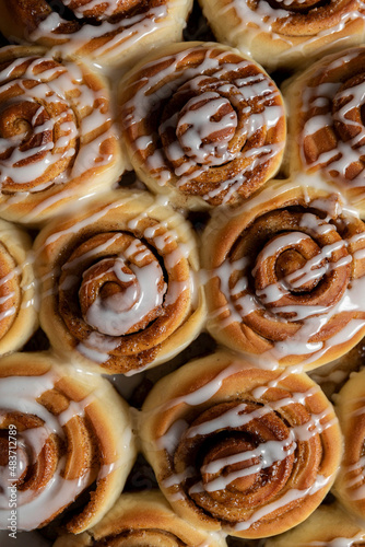 Cinnamon Roll pastries covered in drizzled icing photo