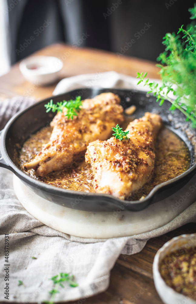 Rabbit with mustard, cooked in a skillet pan Rabbit with mustard, cooked in a skillet pan