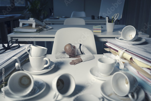 Stressed businessman working overtime in the office