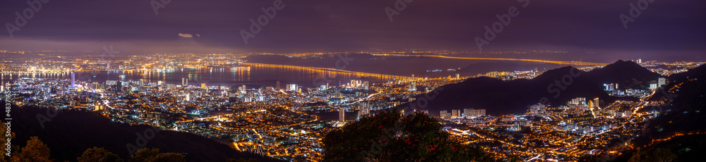 Penang Cityscape at night, showing bridges, temples, mountains.