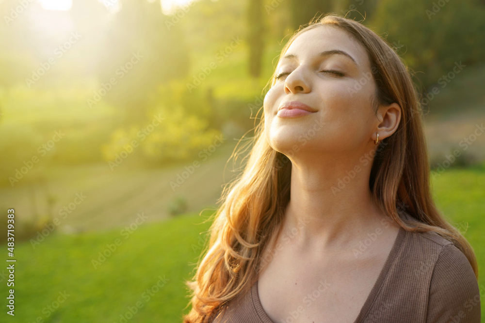 Close-up woman at sunset relaxing breathing fresh air Close-up woman at sunset relaxing breathing fresh air